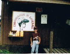 Andy McDougal; in front of Canandaigua Jr Baseball sign